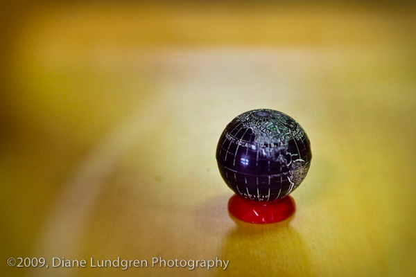 a miniature globe, set inside a display case