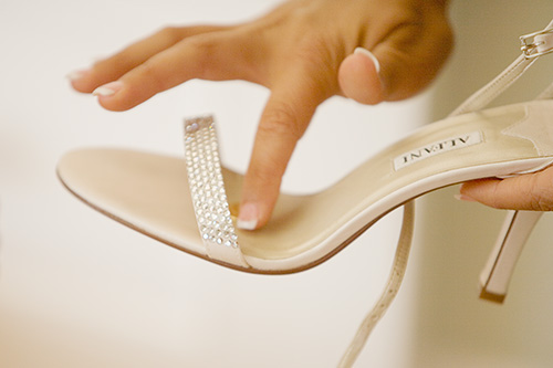 Image of Placing Coin in Bride's Shoe