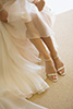 Thumbnail of Bride Putting Shoes on